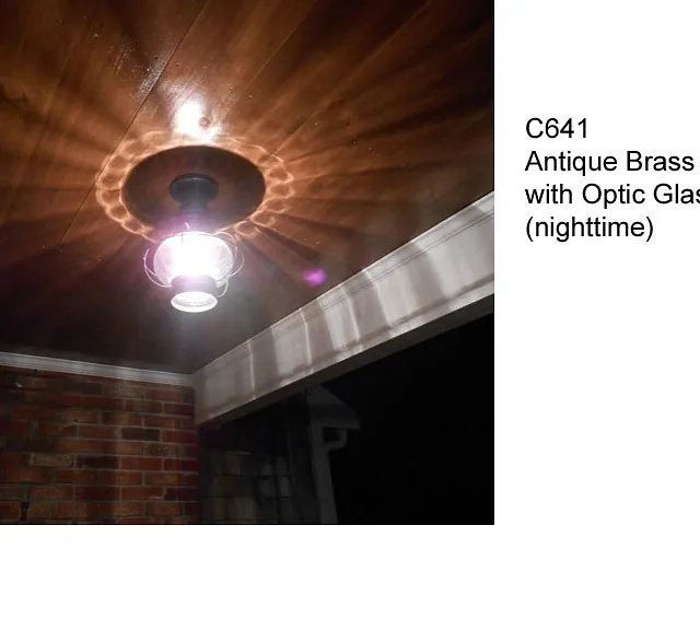 antique brass onion light with optic glass at night
