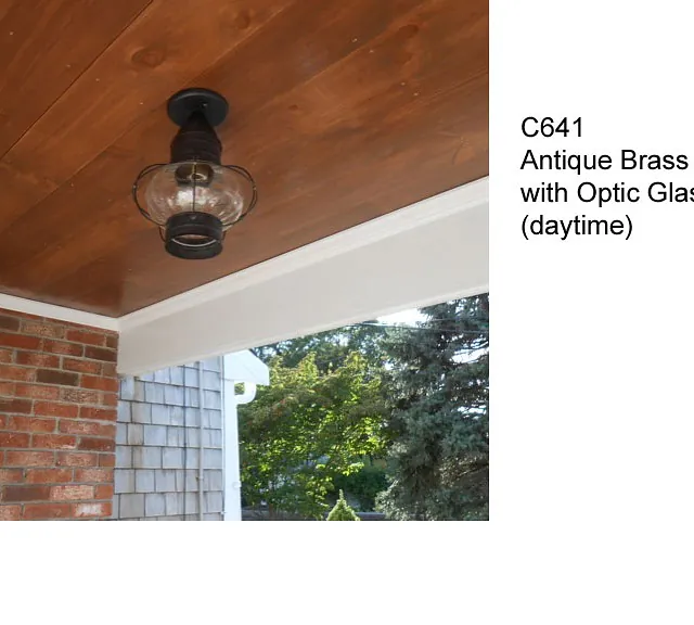 antique brass onion light with optic glass during the day